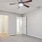 a room with a ceiling fan and a door