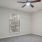 a room with a ceiling fan and a window