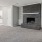 a room with a fireplace and white cabinets