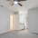 a room with a ceiling fan and a door