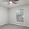 a room with a window and a fan